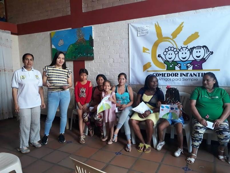 Encuentro de participación con mujeres y niñas junto al logo del comedor infantil